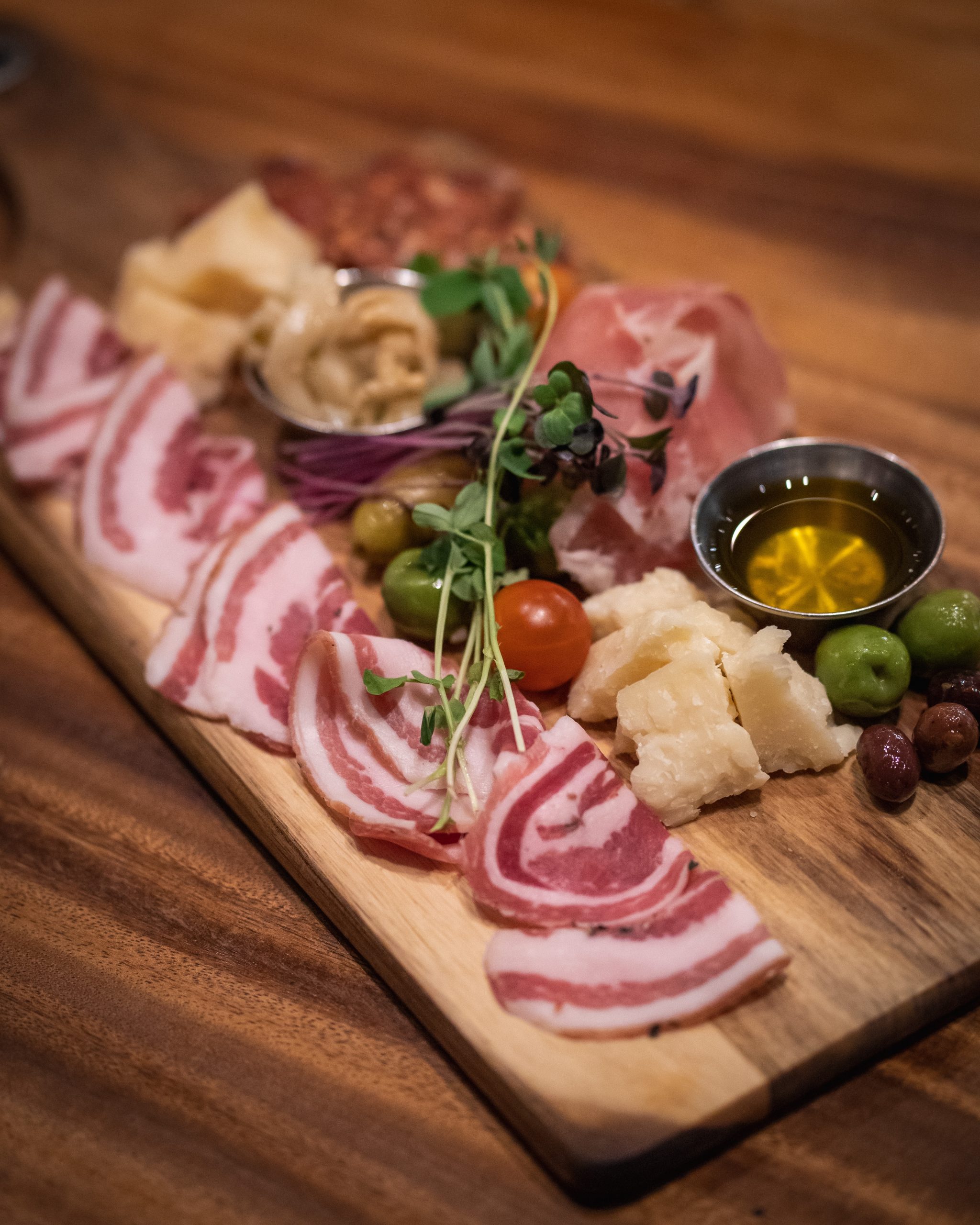Serve your friends a charcuterie board with cured meets, fresh fruits, roasted vegetables, breads, and dips!