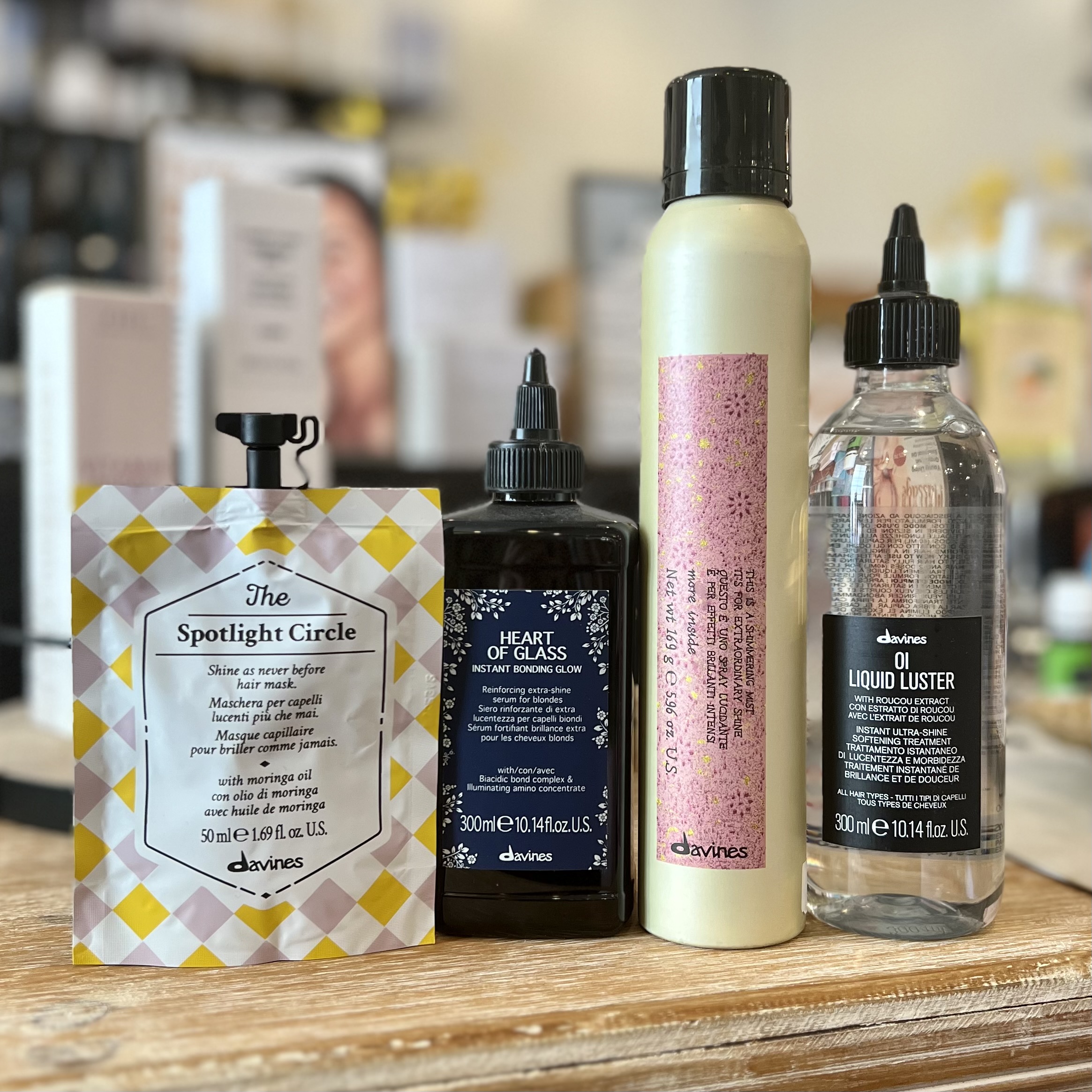 Restore shine to dull hair with Davines' The Spotlight Circle Chronicles Mask, Heart of Glass Instant Bonding Glow Treatment, This is a Shimmering Mist, and Oi Liquid Luster.