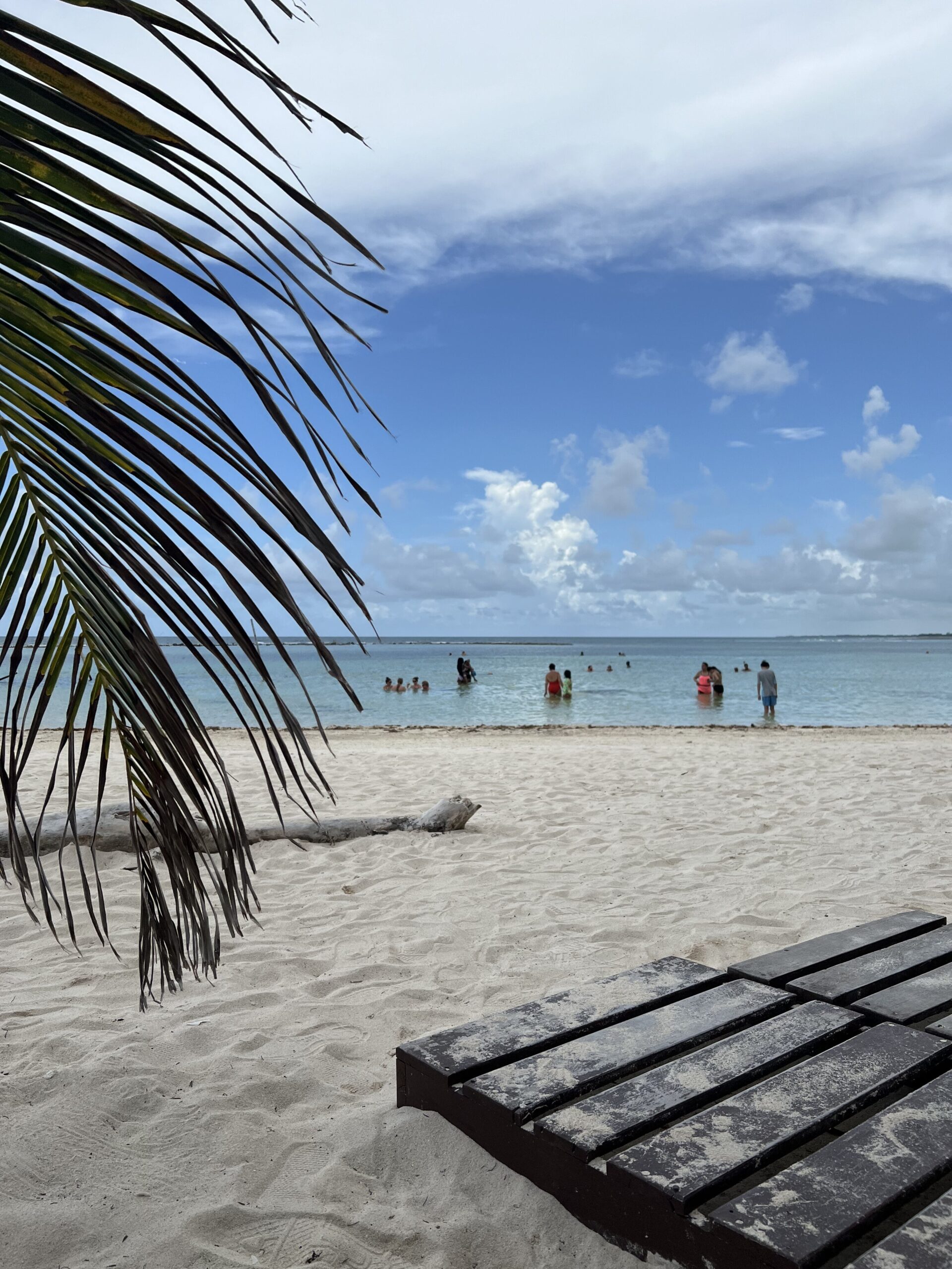 Waves crash alongside the sandy beach's shore on an overcast day in Mahahual, Mexico. 