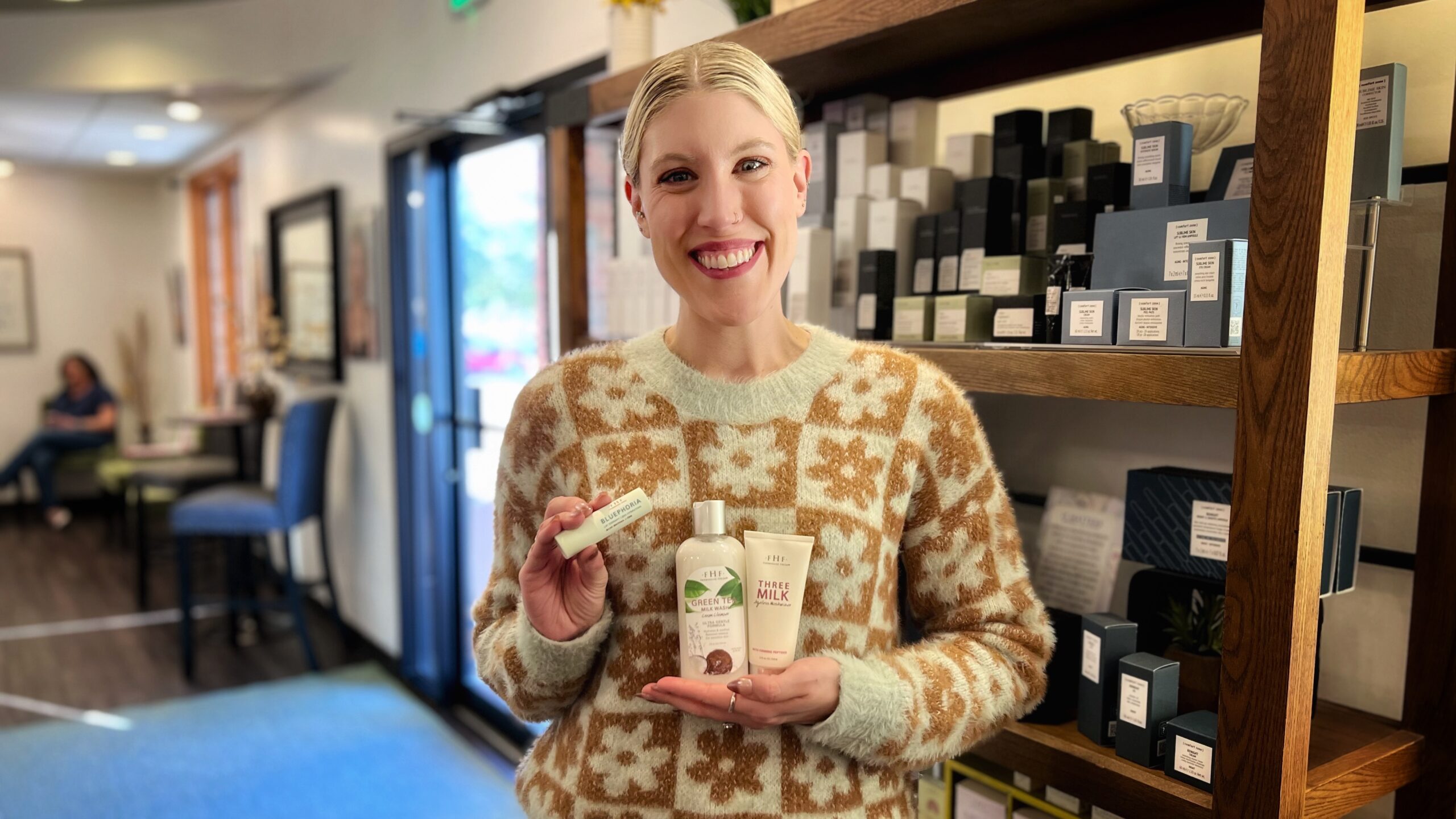 Our daily operations manager Mallorie holds FarmHouse Fresh's Green Tea Milk Wash Cleanser, Bluephoria Lip Therapy, and Three Milk Ageless Moisturizer. These are three of her favorite products to nourish her skin as the weather turns colder.