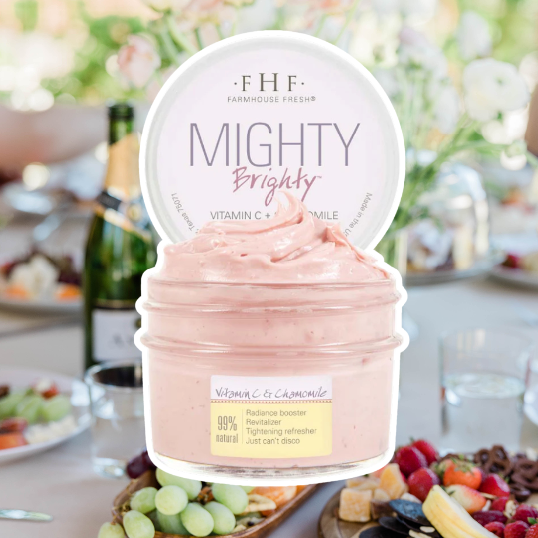 FarmHouse Fresh Mighty Brighty Vitamin C & Chamomile Mask outlined in white, set against a cheerful brunch scene with friends, mimosas, and fresh fruit.
