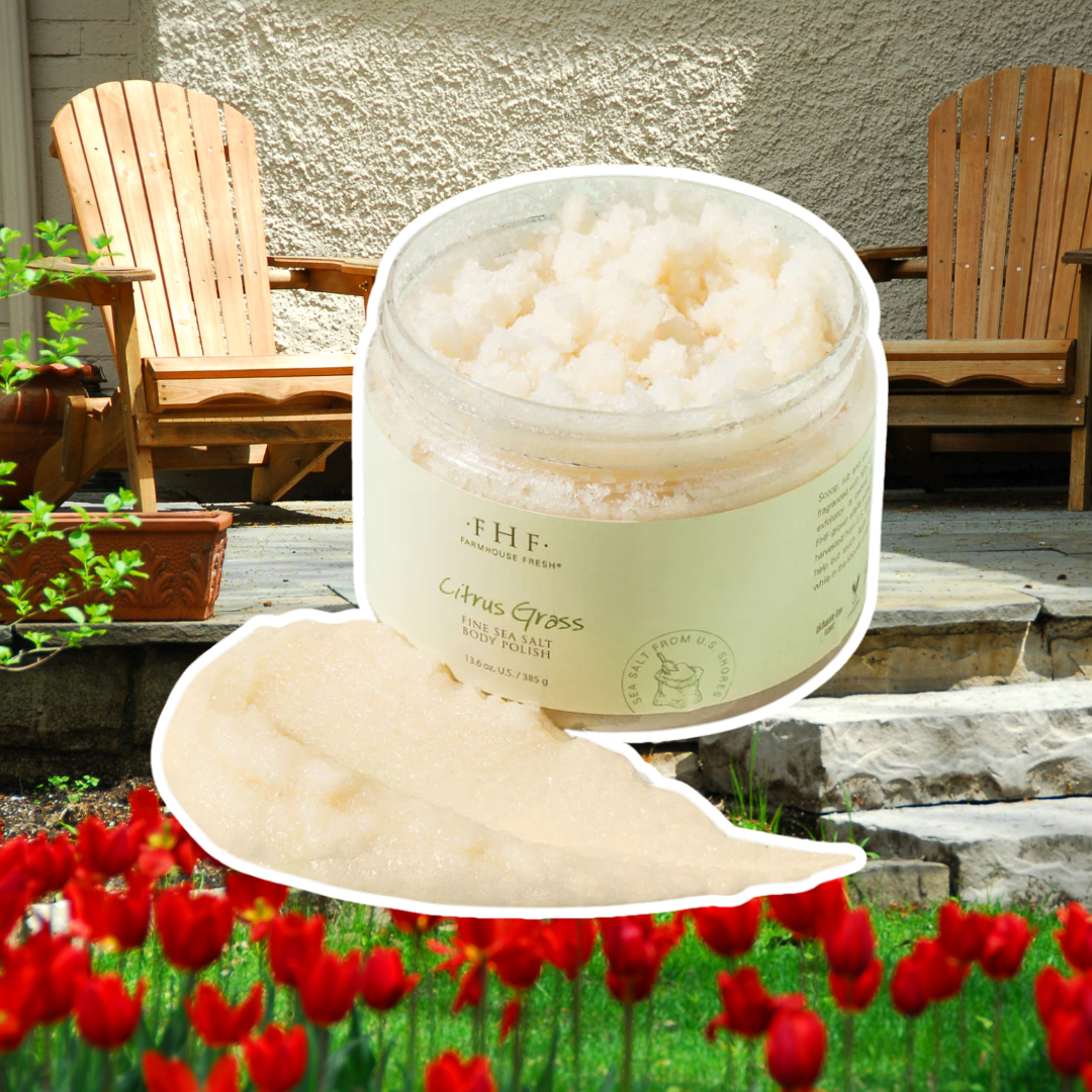 FarmHouse Fresh Citrus Grass Sea Salt Body Polish outlined in white, set against a patio background with an Adirondack chair and red tulips.