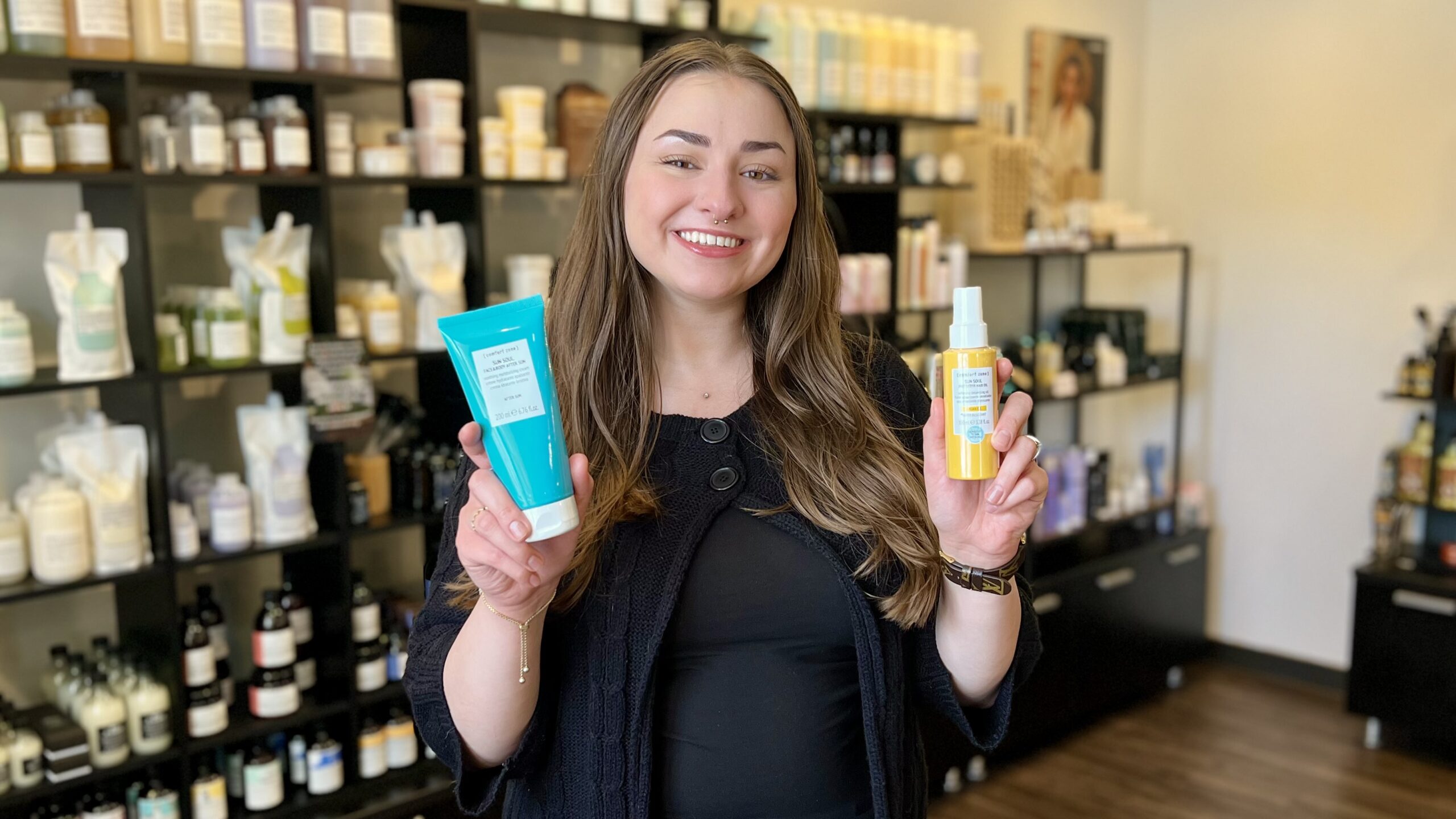 Our guest services representative holds Comfort Zone's new Sun Soul Aftersun and Hair Oil that will help relieve a sunburn.