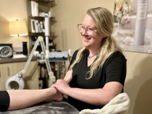 Our massage therapist Sara massages her guest's foot during their Darling Clementine Ritual Massage.