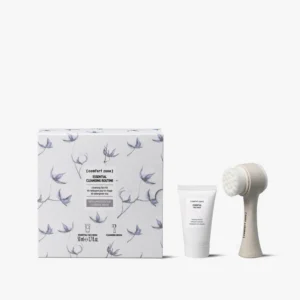 The Revitalizing Lip Care Kit (Copy) features a boxed set with floral design, a tube of cream, and a facial cleansing brush, all displayed on a white background. - Tyler Mason Salon + Spa in Indianapolis, IN