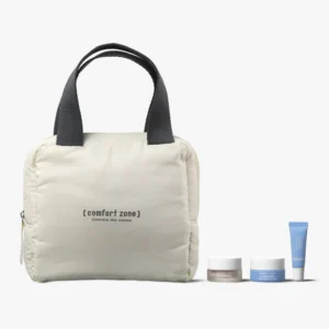 A beige pouch with black handles labeled "Comfort Zone" is displayed next to the Revitalizing Lip Care Kit, which includes two small jars and a blue tube of skincare products. - Tyler Mason Salon + Spa in Indianapolis, IN