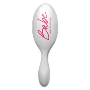 A Wet Brush-Pro Detangler with "Babe HAIR EXTENSIONS" in pink and red text on the back. - Tyler Mason Salon + Spa in Indianapolis, IN