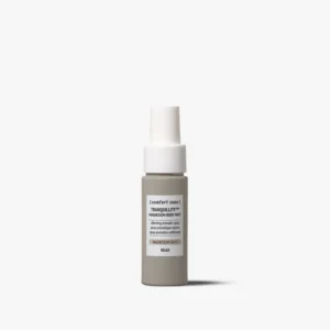 A small bottle of Tranquillity™ Magnesium Body Mist, with a gray base, white label, and white spray cap, is shown against a plain white background. - Tyler Mason Salon + Spa in Indianapolis, IN