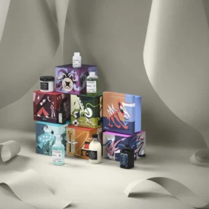 A display of VOLU Conditioner (Copy) bottles arranged on and around six colorful boxes featuring stylized animal illustrations, set against a neutral background with draped paper. - Tyler Mason Salon + Spa in Indianapolis, IN